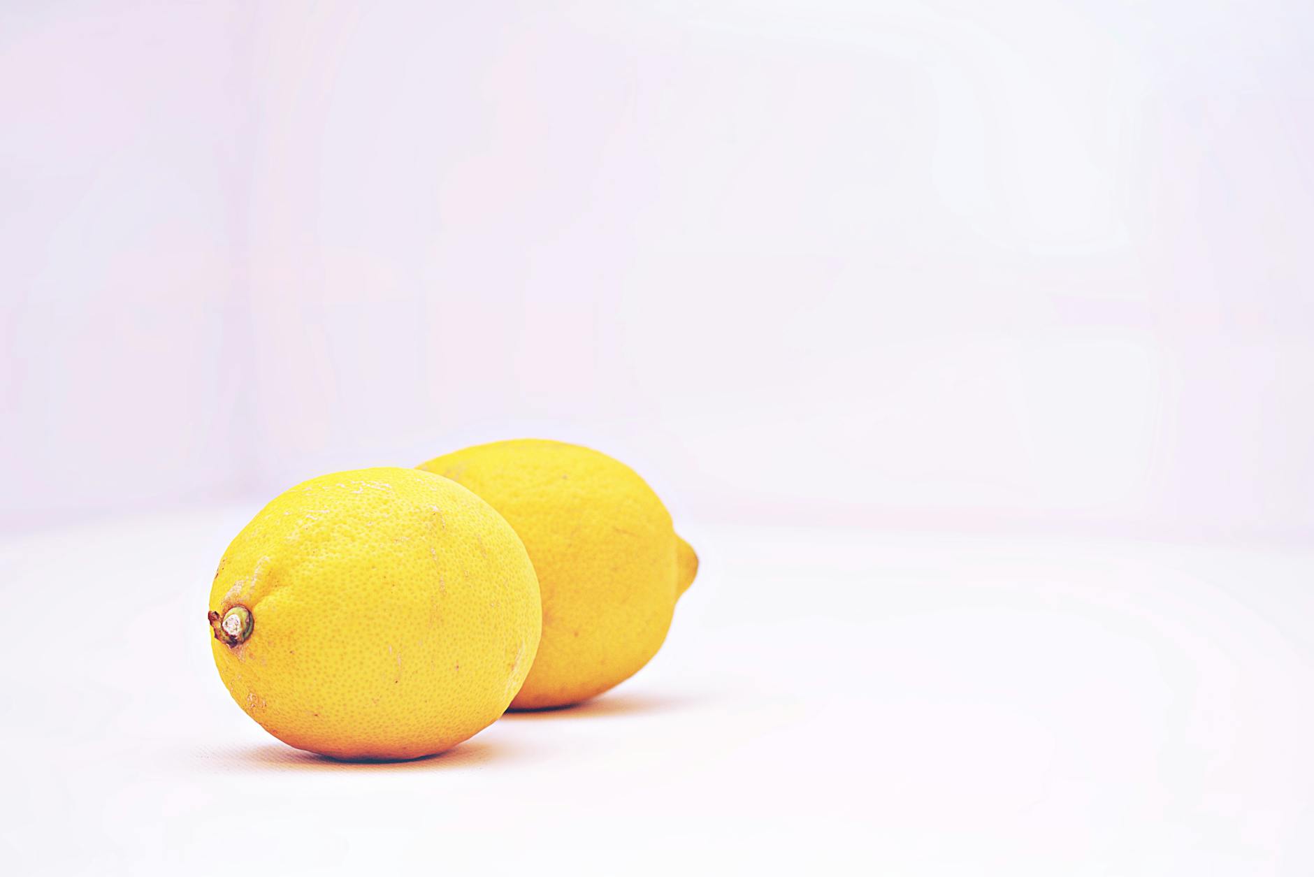 Two vibrant lemons against a minimalistic white background, representing fresh sensitivity shifts