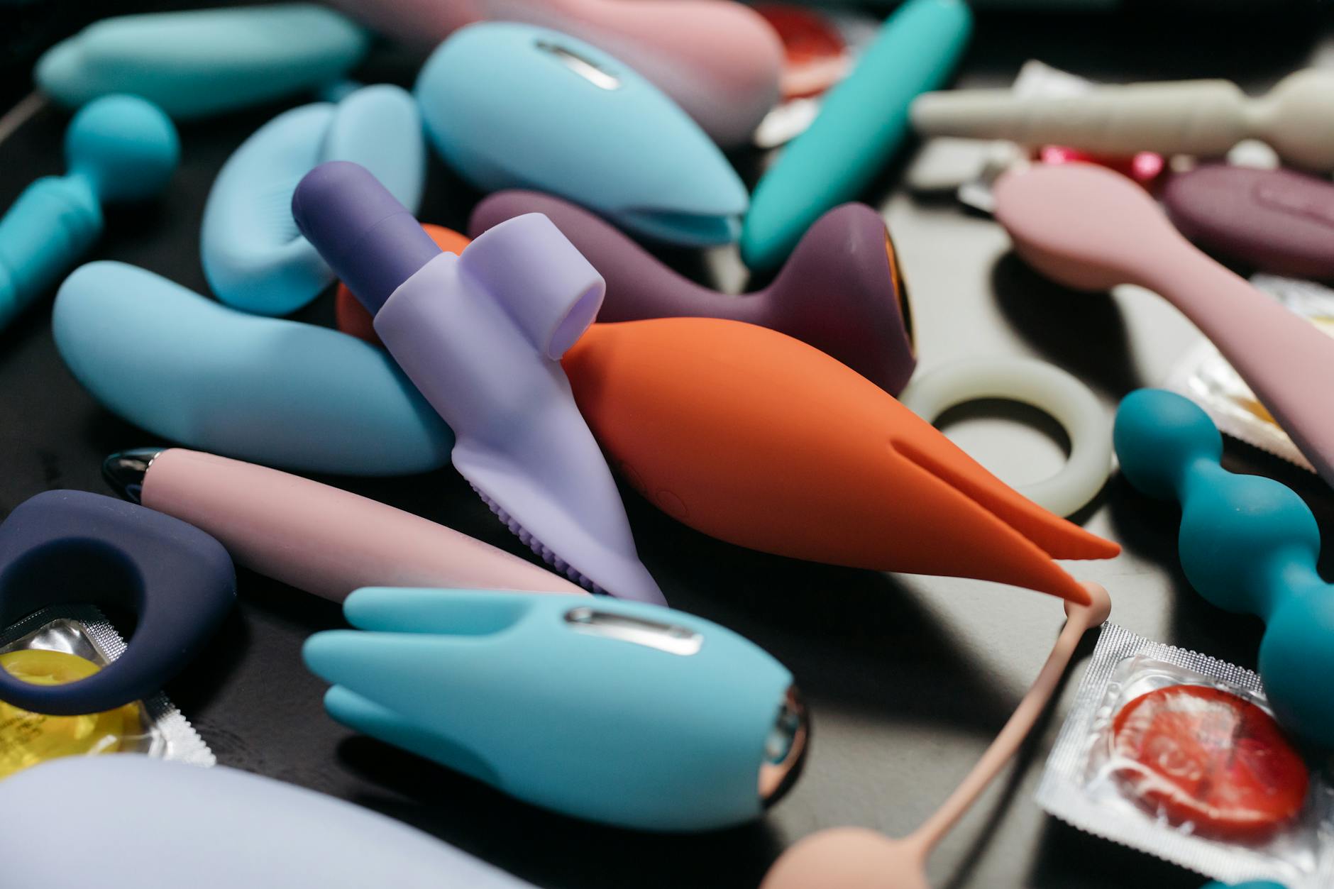Hand holding a lemon vibrator against a purple backdrop, showcasing modern pleasure tools