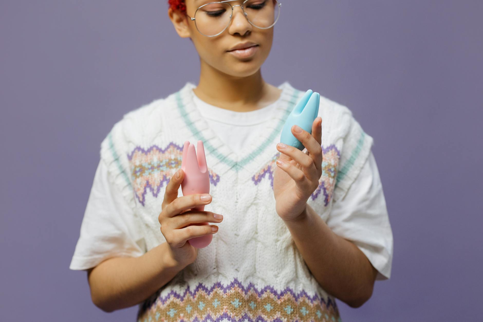Woman holding delicate vibrators thoughtfully during a moment of self-care and stress relief